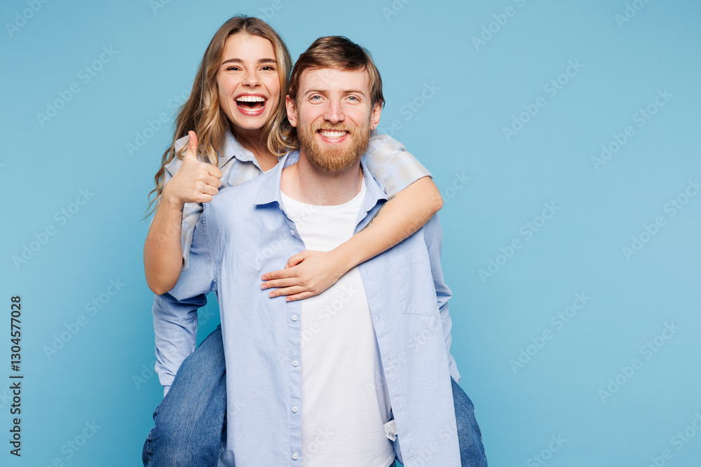 Young happy couple two friends family man woman wear shirt casual clothes together giving piggyback ride to joyful, sit on back isolated on pastel plain light blue background studio Lifestyle concept Young happy couple two friends family man woman wear shirt casual clothes together giving piggyback ride to joyful, sit on back isolated on pastel plain light blue background studio Lifestyle concept