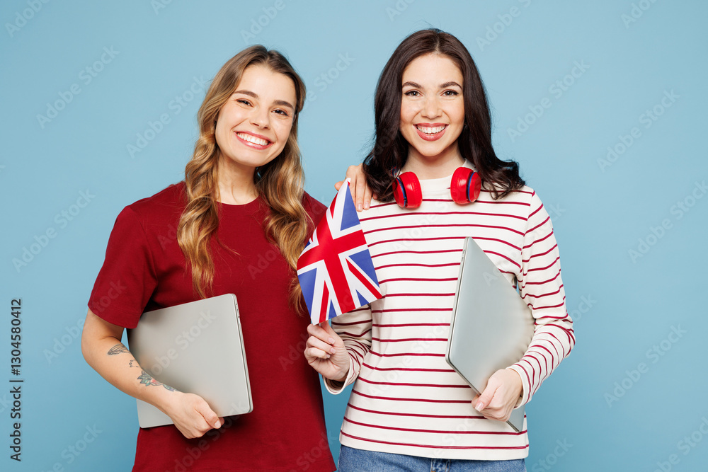 Young smart fun IT couple two friends women wearing red casual clothes headphones together hold British flag closed laptop pc computer isolated on pastel plain blue cyan background. Lifestyle concept. Young smart fun IT couple two friends women wearing red casual clothes headphones together hold British flag closed laptop pc computer isolated on pastel plain blue cyan background. Lifestyle concept.
