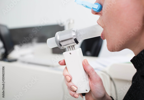 Behang unrecognizable patient having lung function test at hospital