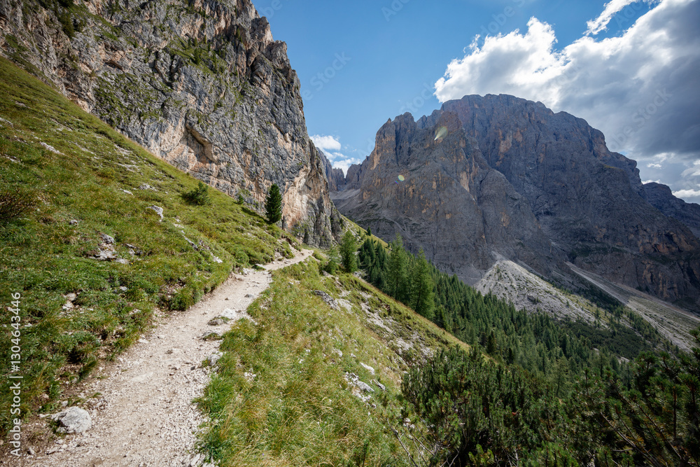 Scenic hiking trail winding through the stunning Dolomite mountains in Italy on a sunny day Scenic hiking trail winding through the stunning Dolomite mountains in Italy on a sunny day