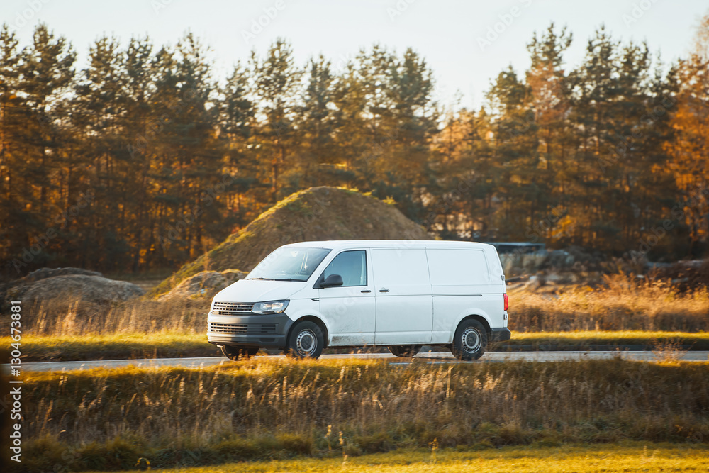 White van driving along autumn landscape White van driving along autumn landscape