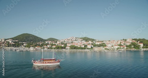 Wide static shot of boats, marina, and hillside houses across Dubrovnik, Croatia. For projects requiring longer clips in higher resolution, visit StockPlates.
