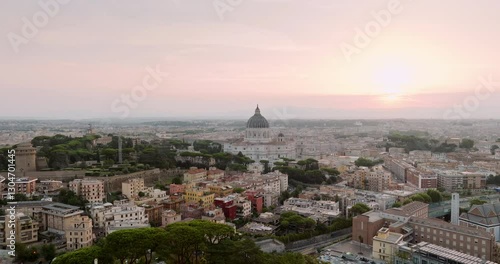 Wallpaper Mural Drone shot capturing Vatican City and Rome skyline at dawn. Sun rises behind St. Peter Basilica, illuminating the city historic structures Vatican Gardens in warm hues sunrise summer. Travel Torontodigital.ca