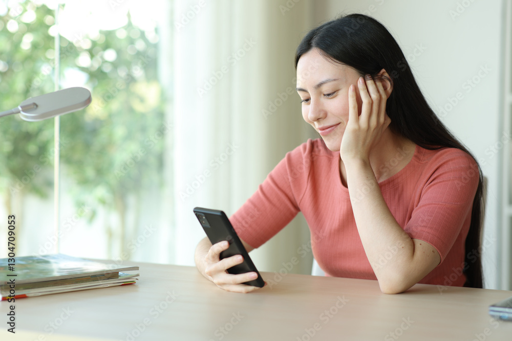 Satisfied asian woman using smart phone in a room Satisfied asian woman using smart phone in a room