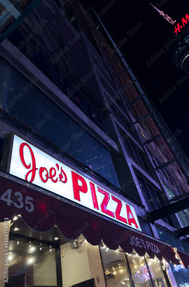 Naklejka premium New York City, USA, April 1, 2024: Joe's Pizza building façade in Greenwich Village, NYC. Established in 1975 by Joe Pozzuoli.