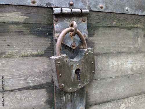 A classic, rusty, heavily worn padlock (horizontal photo)
