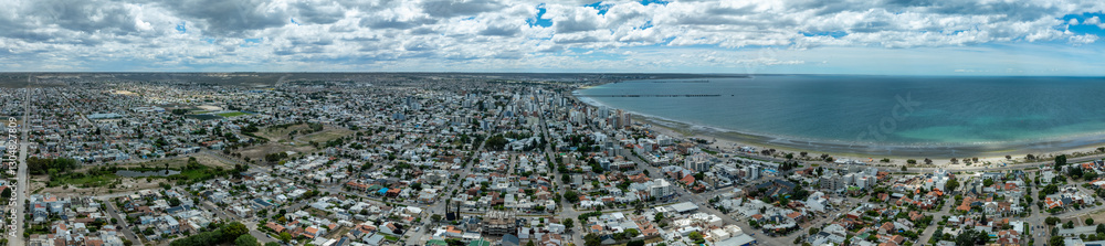 Aerial panoramic shot of Puerto Madryn city located by the Ocean on a beautiful day. Chubut, Argentina Aerial panoramic shot of Puerto Madryn city located by the Ocean on a beautiful day. Chubut, Argentina