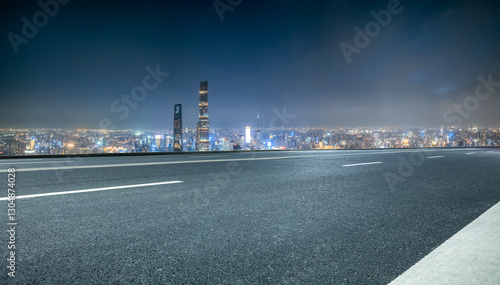 Fototapeta Naklejka Na Ścianę i Meble -  Empty asphalt road and modern city skyline at night