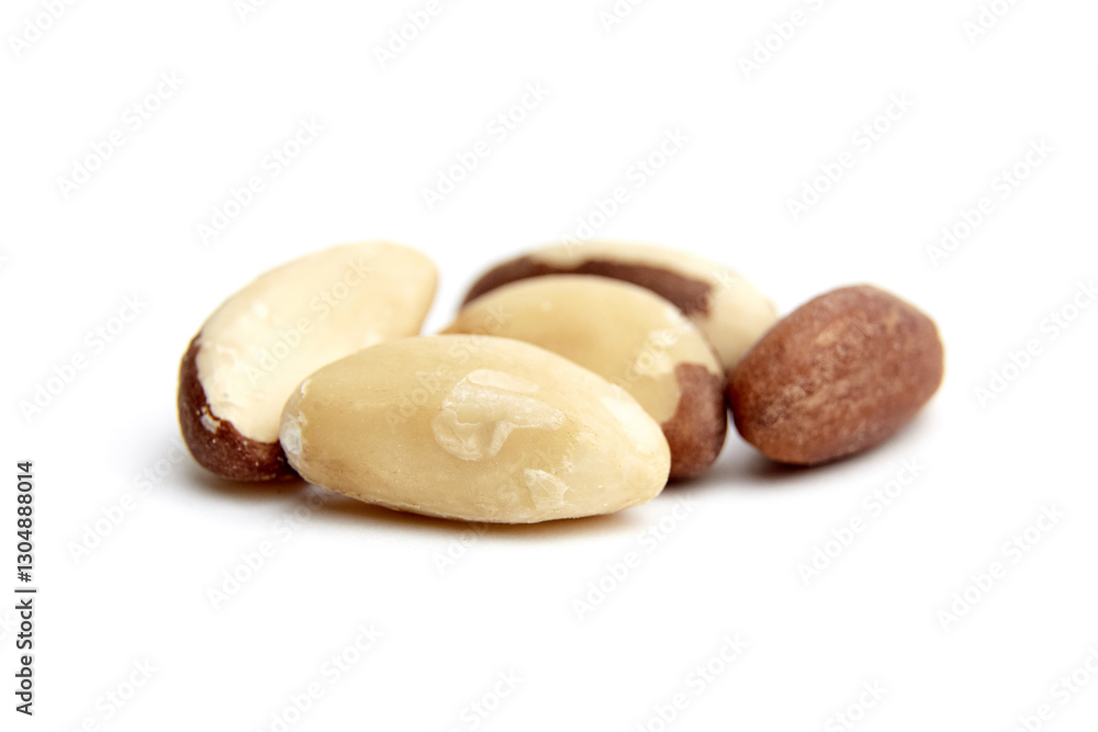 A small cluster of Brazil nuts showcasing smooth, creamy surfaces and natural brown patches, arranged on a white background for a close-up view A small cluster of Brazil nuts showcasing smooth, creamy surfaces and natural brown patches, arranged on a white background for a close-up view