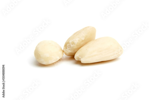 Photos Close-up of three blanched almonds with smooth texture, arranged on a clean white background