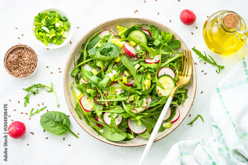 Green salad with spinach, arugula and radish with olive oil.