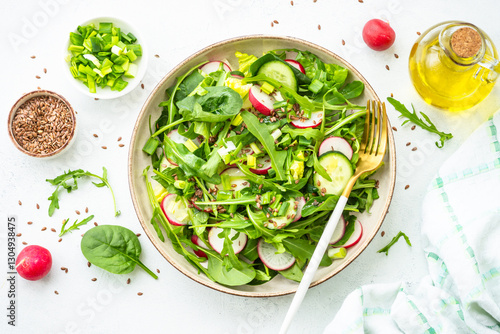 Green salad with spinach, arugula and radish with olive oil.