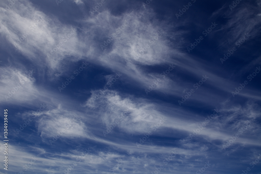 Wispy white clouds against a dark blue sky Wispy white clouds against a dark blue sky