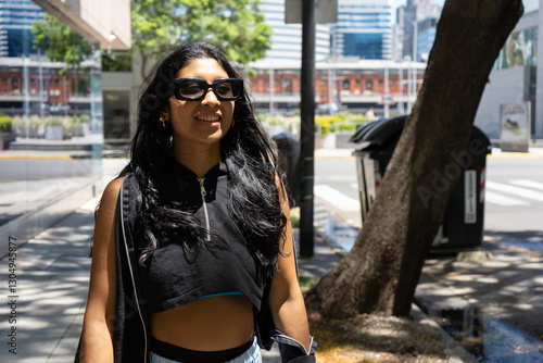 Latin sportswoman walking in a modern city during a sunny day photo