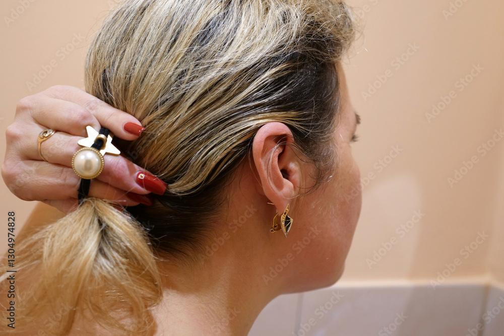 Naklejka premium A woman combs her hair in the morning. Hair care.