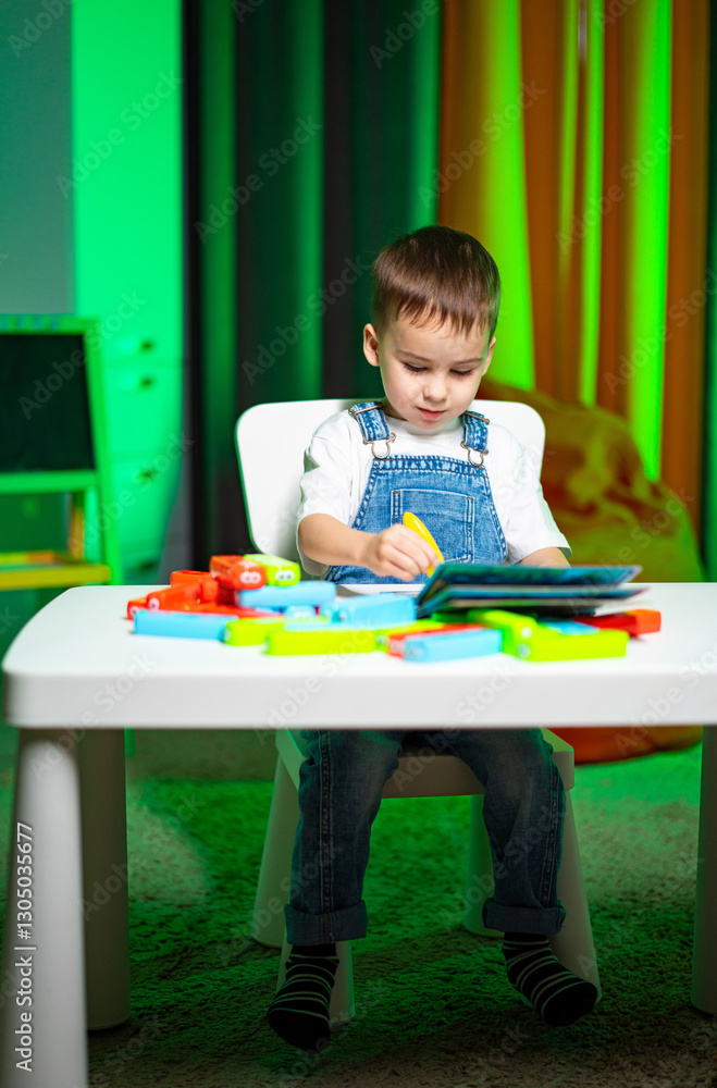 Child engages in creative play at home. A young boy sits at a table, coloring and playing with colorful blocks in a cozy, brightly lit room. Child engages in creative play at home. A young boy sits at a table, coloring and playing with colorful blocks in a cozy, brightly lit room.