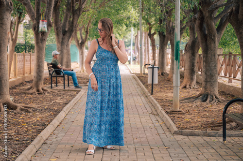 Woman sits on the bench in ...
