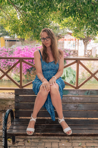 Woman sits on the bench in ...