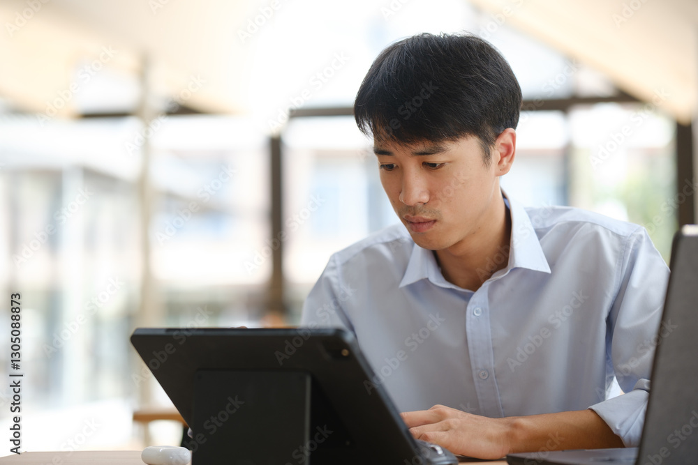 Business consultant analyzing financial data on a laptop Business consultant analyzing financial data on a laptop