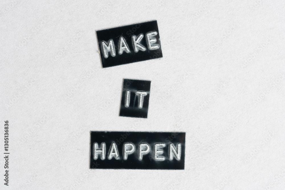 Obraz premium Make it happen words on white paper background. Motivational and inspirational quotes.