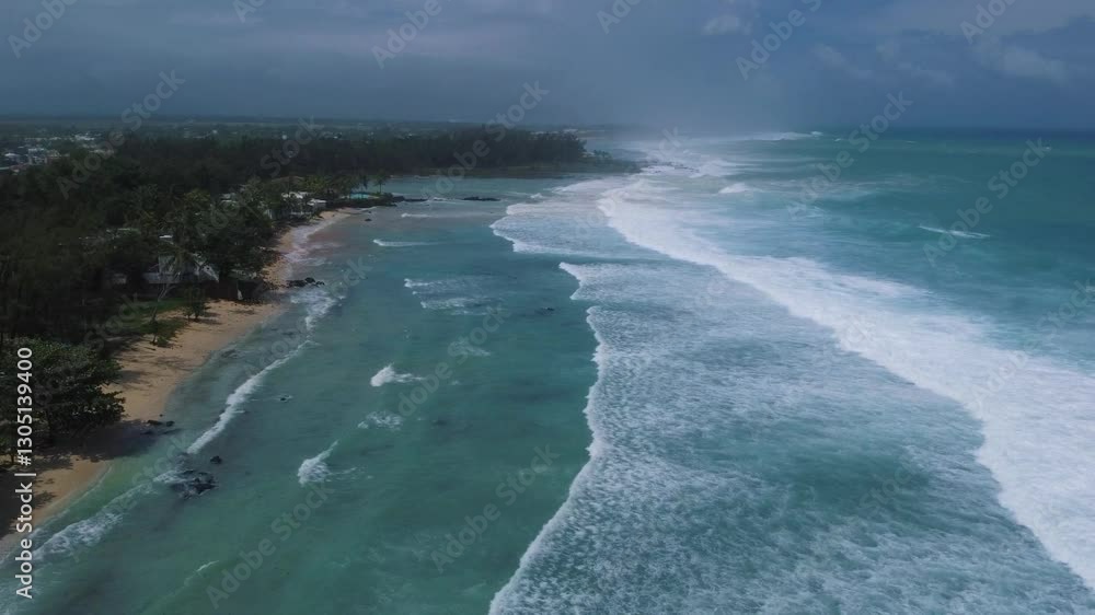 Aerial view of powerful high waves crashing in the Indian Ocean during a cyclone in Mauritius, capturing the intensity of the storm Aerial view of powerful high waves crashing in the Indian Ocean during a cyclone in Mauritius, capturing the intensity of the storm