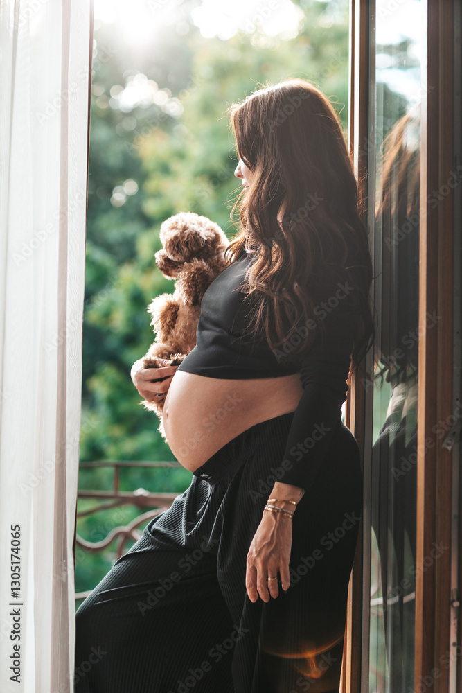 Beautiful pregnant woman at home in the doorway