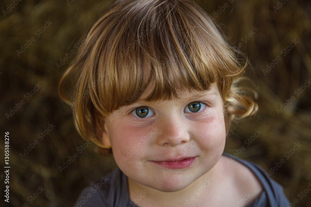 Close-Up Portrait of a Smiling Child with Brown Hair and Green Eyes in Natural Light Close-Up Portrait of a Smiling Child with Brown Hair and Green Eyes in Natural Light