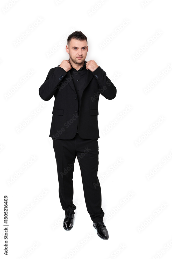A handsome dark-haired man wearing a business suit, a black shirt on a white background A handsome dark-haired man wearing a business suit, a black shirt on a white background