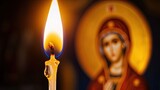 single candle, lit in front of an icon of the revered Saint Mary and Theotokos