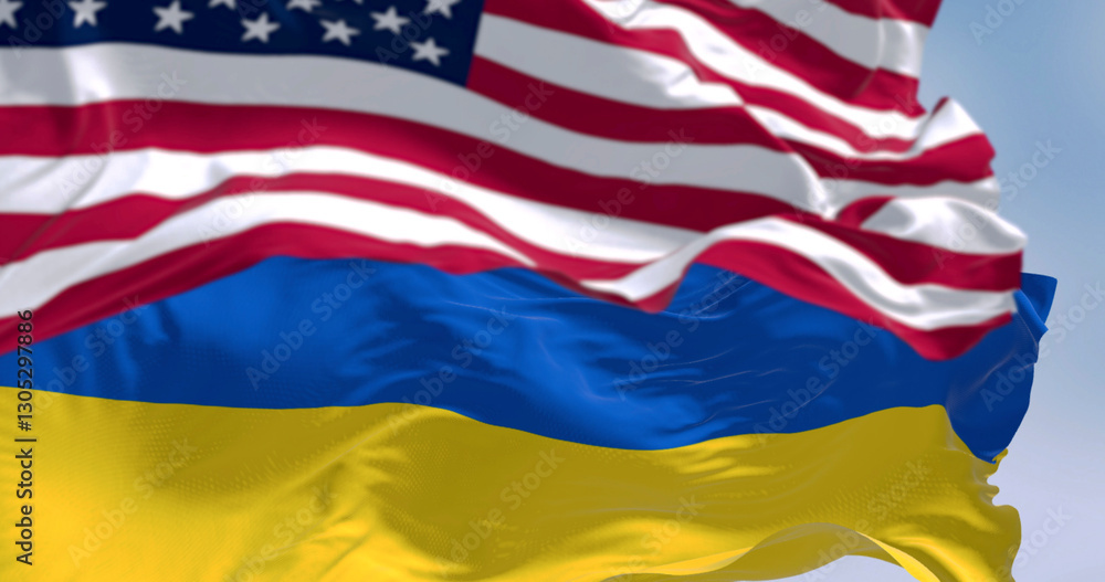 Close-up of Ukraine and US national flags waving on a clear day Close-up of Ukraine and US national flags waving on a clear day