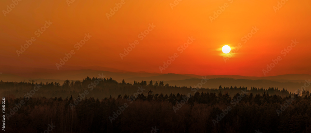 Sunset over mountains on the horizon.