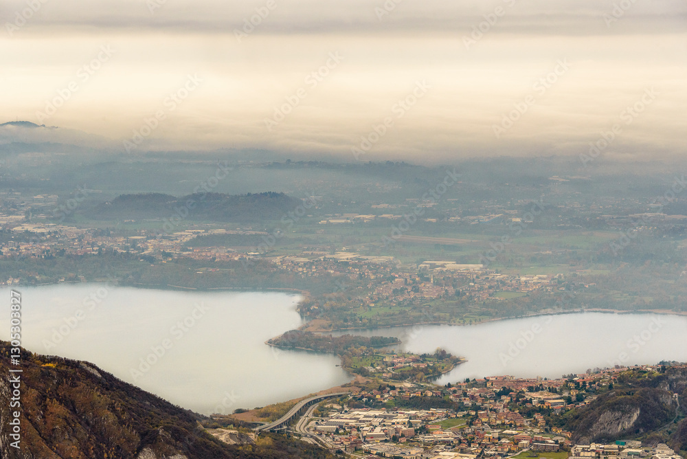 Fototapeta premium top view of the Como Lake from the Resinelli Piani in a foggy morning, Lecco province, Italy