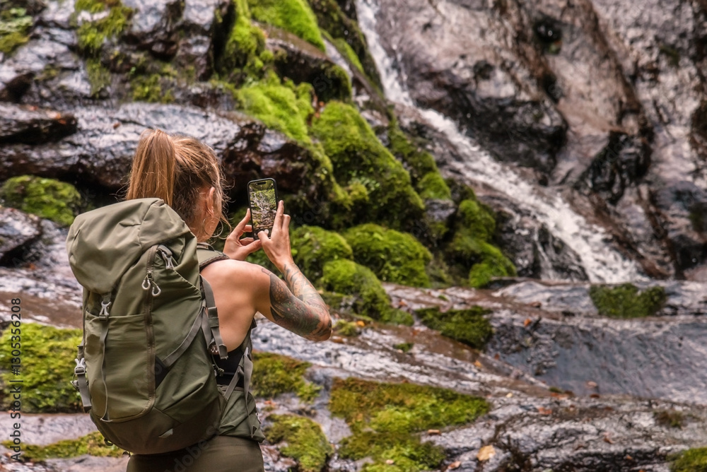 Woman Traveler Taking Picture of Mountain Waterfall