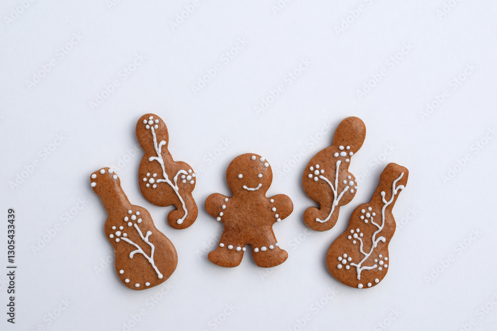 Romantic decorated gingerbread cookies in a shape of guitar, treble clef and man, white background, copy space for text. Musical theme Romantic decorated gingerbread cookies in a shape of guitar, treble clef and man, white background, copy space for text. Musical theme