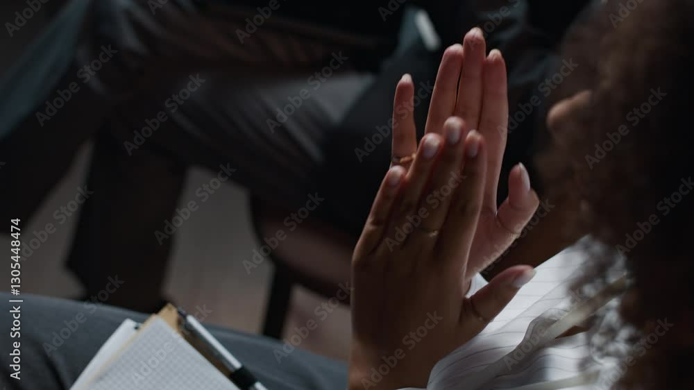 High angle view of unrecognizable young Black woman clapping hands at business conference High angle view of unrecognizable young Black woman clapping hands at business conference