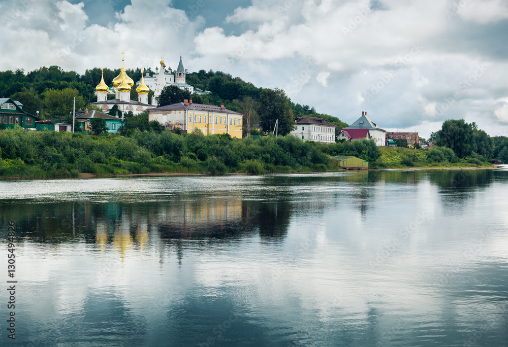 Fototapeta premium Klyazma River and view of Orthodox Temples in Gorokhovets. Vladimir Oblast, Russia. Holy Trinity Cathedral - the main church of St. Nicholas Monastery. Annunciation Cathedral, Blagoveshchenskiy Sobor