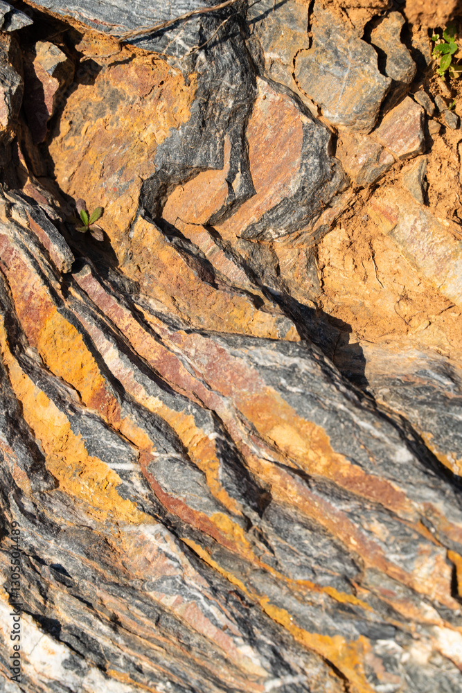 The background is a beautiful rough stone texture in close-up with bright colors of mineral inclusions The background is a beautiful rough stone texture in close-up with bright colors of mineral inclusions