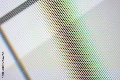 A close-up view shows a grid pattern with diagonal lines that are pastel colors. The lines create a textured visual effect that resembles pixelation or a digital screen. photo