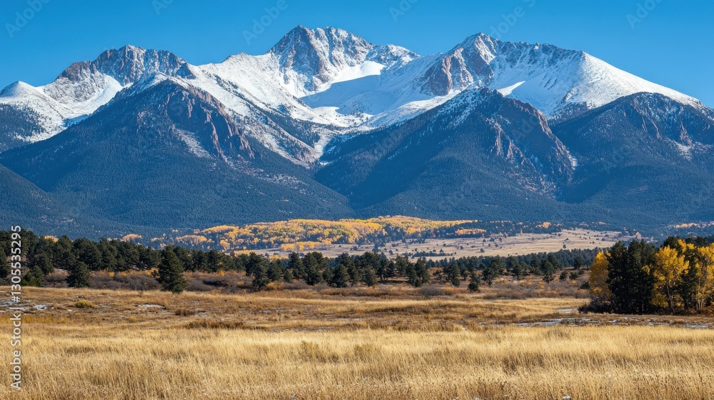 Majestic snow capped mountain range and golden grassy plains
