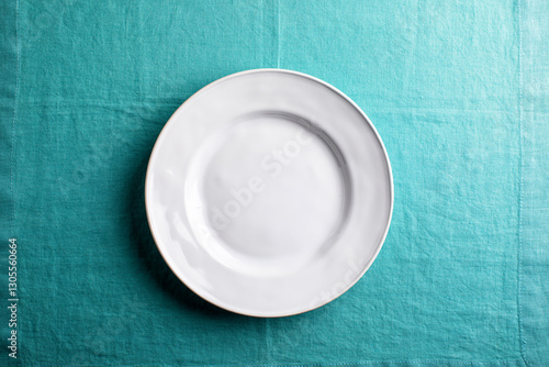 white plate on aqua linen , overhead
