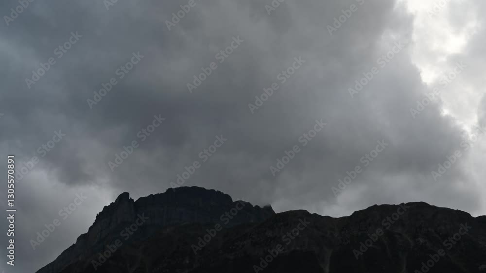Time lapse of grey storm clouds blowing across the top of a rocky mountain ridge
Time lapse of grey storm clouds blowing across the top of a rocky mountain ridge