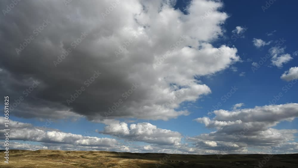 Timelapse of blowing white and grey storm clouds moving between mountains above a forest
Timelapse of blowing white and grey storm clouds moving between mountains above a forest