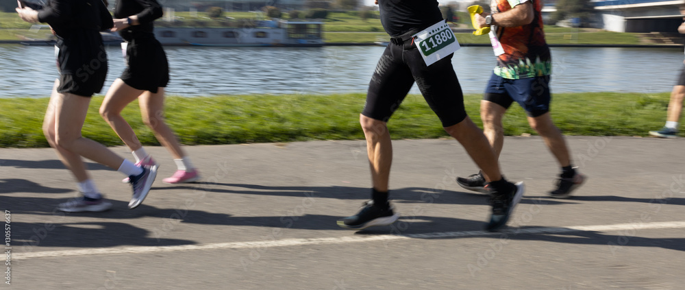 Motion blurred marathon runners in a city. Group of marathon runners compete in the race outdoors Motion blurred marathon runners in a city. Group of marathon runners compete in the race outdoors