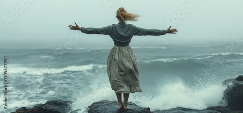 Woman embracing the stormy sea on a cliff, seeking freedom and nature's strength