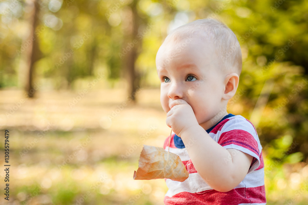 Close-up portrait of a little boy teething and chewing on his hand Close-up portrait of a little boy teething and chewing on his hand
