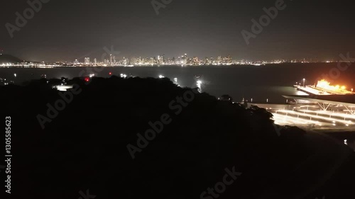 Cinematic aerial view from a drone at night on the Amador Causeway in Panama City, 4K Video