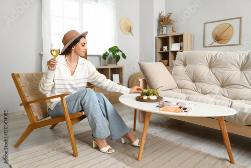 Young woman with glass of w...