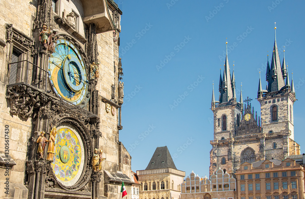 Obraz premium The historic Old Town Hall with its astronomical clock mounted on its side and the Gothic Church of our Lady before Týn, tower over Old Town Square in Prague, Czech Republic on a summer day.