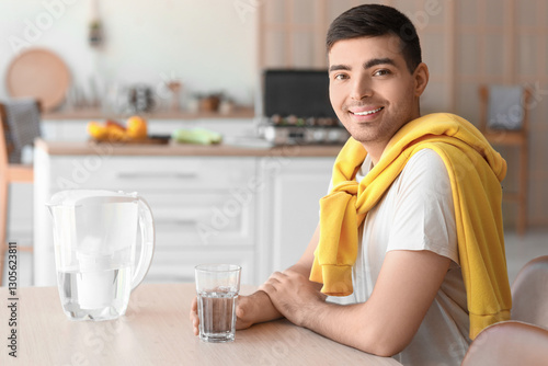 Smiling young man with wate...
