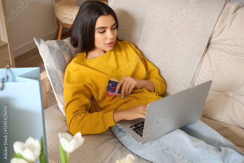 Young woman with laptop and...